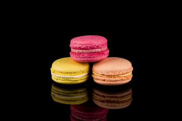 Colorful macaroon over black background