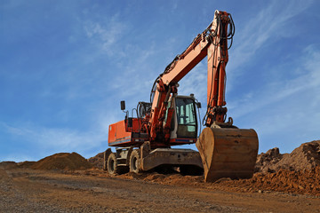 big red excavator on construction site