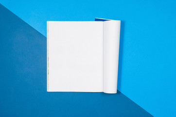 Mock-up magazine or catalog on colorful table. White page or notepad on modern background. Blank copy space for mockups or simulations.