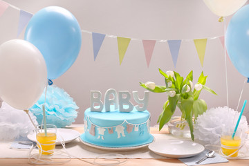 Birthday blue cake and balloons on party or reception