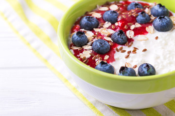 Oatmeal with blueberries, raspberry jam, flax seeds and yogurt