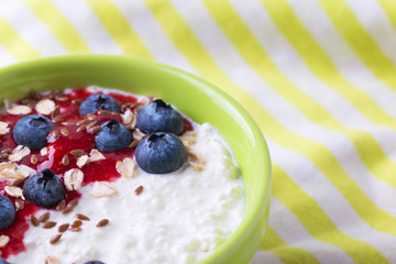 Oatmeal with blueberries, raspberry jam, flax seeds and yogurt