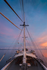Obraz premium Indonesian Sunset from a Schooner Sailboat. Sailing through the Raja Ampat archipelago on a traditional phinisi schooner during a glorious sunset. 