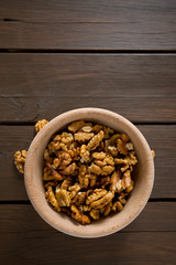 walnuts in a bowl on wooden surface