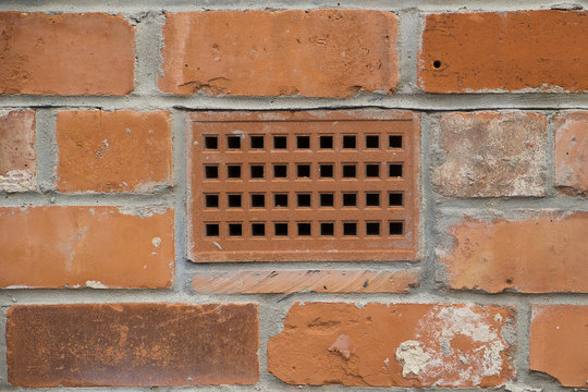 Fototapeta brick wall with a close up showing a ventilation brick