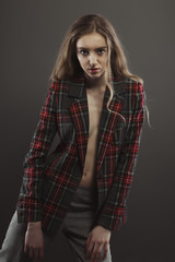 Attractive young model posing for model tests  in tartan jacket