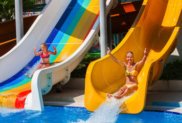 Swimming pool slides for children on water slide at aquapark and thumb up. Summer holiday mood...