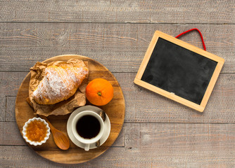 Coffee and croissant for breakfast, top view