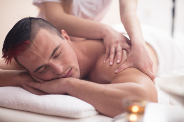 Fototapeta na wymiar young man having a back massage