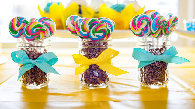Lollipops in jars with bow ribbons