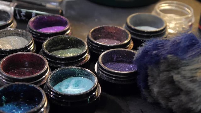 Makeup palette with Brushes. Shiny glitter on makeup. Closeup.