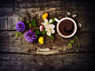 A cup of coffee on a wooden texture.