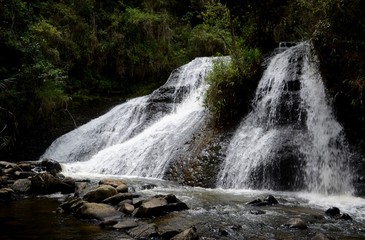Fototapeta premium Bright white cascading waterfall in the forest near Villa de Leyva. 