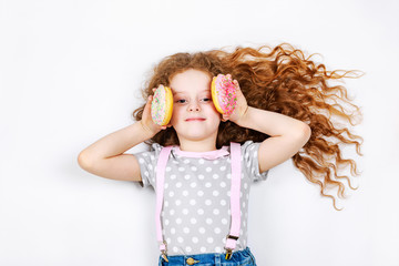 Funny little girl  with donuts.