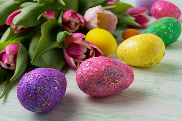 Easter background with glitter decorated eggs
