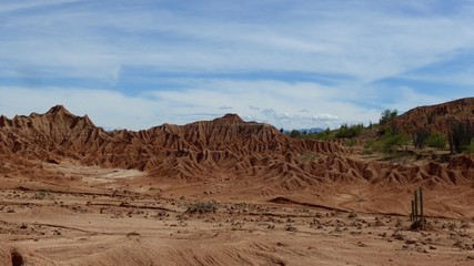 Landscape view of dark red fragile soil that's been heavily eroded in the Tatacoa desert in Colombia.