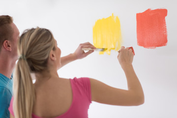 couple painting interior wall