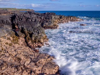 Lava rock off stunning glass beach near Port Allen town on Kauai Hawaii.