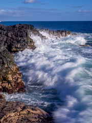 Lava rock off stunning glass beach near Port Allen town on Kauai Hawaii.
