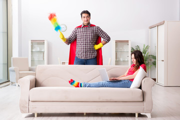 Superhero husband helping his wife at home