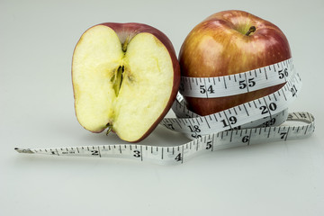 closeup of apple and measurement tape .