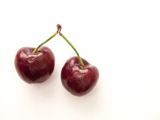 Two red cherry on white background