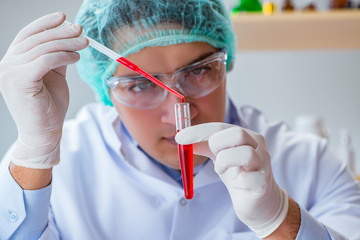 Young doctor working on blood test in lab hospital