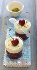 Cherry jelly with cream, pistachio and cherry on top dessert