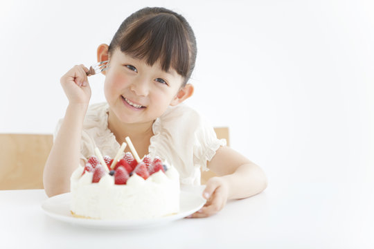 A girl eating a cake