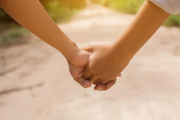 Two people hold hands