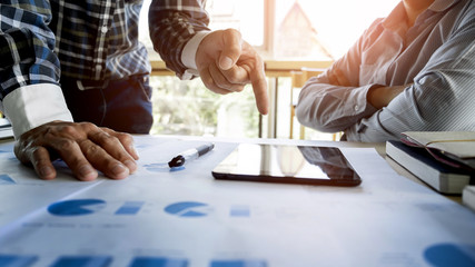 Team work process. young business managers crew working with new startup project. labtop on wood table, typing keyboard, texting message, analyse graph plans