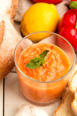 Gazpacho, bread with pesto and vegetables close-up.