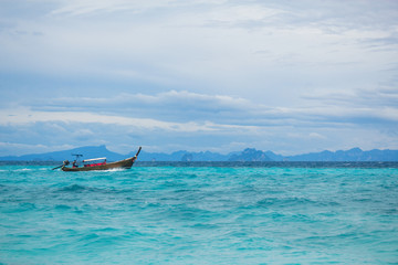 The boat in the ocean. The motor boat sailing in turquoise ocean. Horizontal outdoors shot.