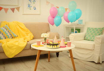 Decorated Birthday room with tasty cake on table