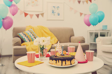 Decorated Birthday room with tasty cake on table