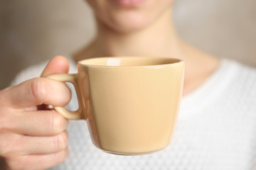Blank color cup in hand, closeup
