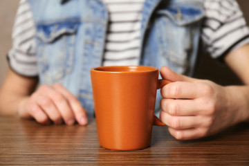 Woman holding blank cup, closeup