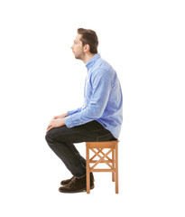 Incorrect posture concept. Man sitting on chair isolated on white