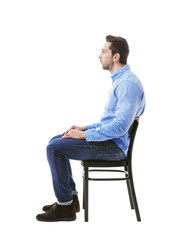 Incorrect posture concept. Man sitting on chair isolated on white