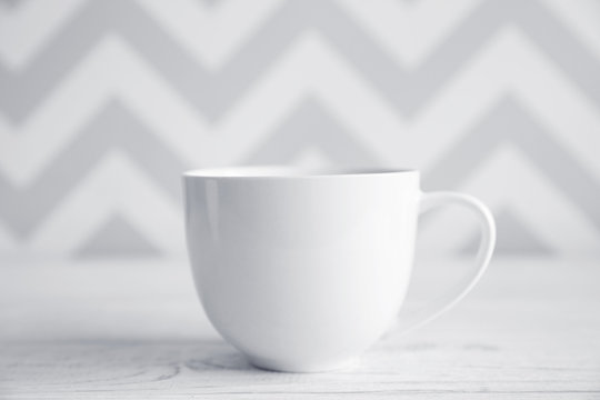 Blank cup on white table