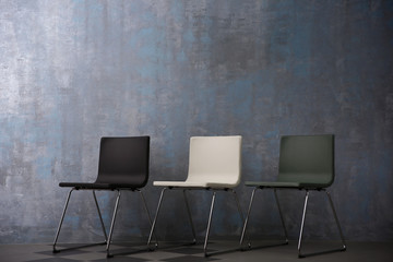 Chairs on grey wall background