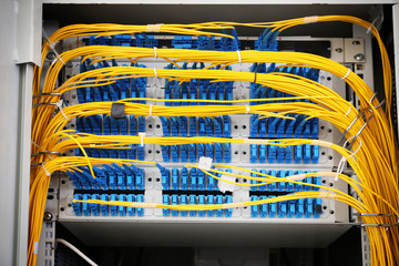 View of open cabinet with wires in server room, closeup