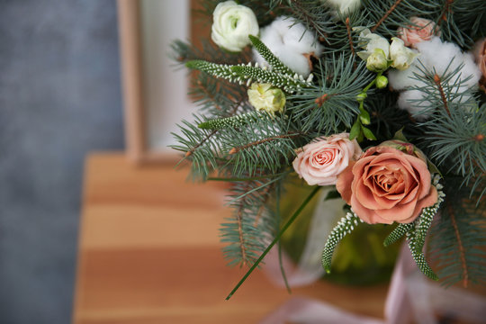Beautiful flowers with fir tree branches, closeup