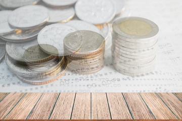 Double exposure of money coins stack for finance and banking concept, Empty wood table top, perspective wood can be used for display products.