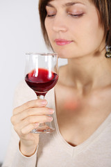Young woman tasting pink wine