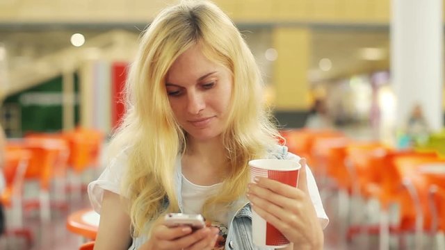 Woman Using Cell Phone at a Shopping Center