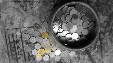 golden coin and coin in donation bowl 