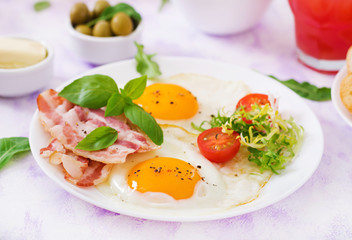 English breakfast - fried egg, tomatoes and bacon.