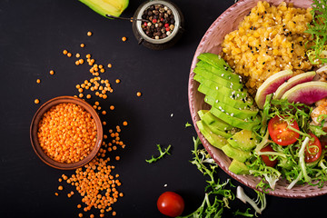Healthy salad with chicken, tomatoes,  avocado, lettuce, watermelon radish and lentil on dark background. Flat lay. Top view