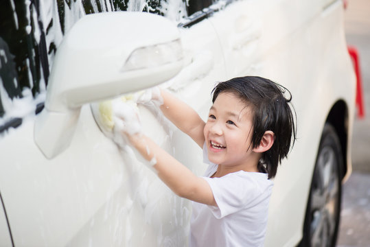Asian children washing car